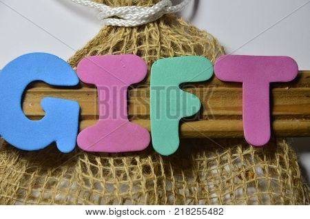 word  gift  on an   abstract colored background