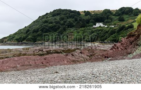 The rocks and pebbles of Talland Bay beach in Cornwall