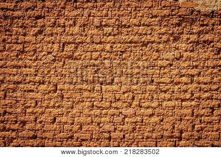 A typical mud brick wall of a house in Uganda
