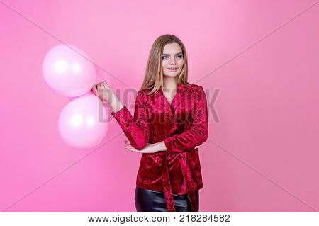 Beautiful girl with balls on a bright background a party holidays