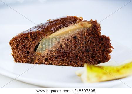 A slice of pear brownie pie with pieces of pear