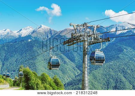 Cable way to the mountains at sunny day time.