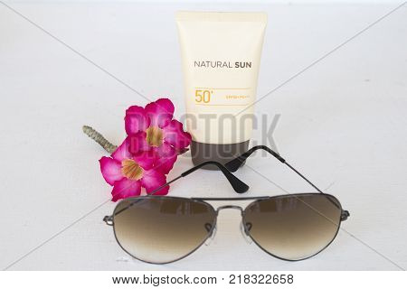 natural sun cosmetics for skin face sunscreen spf50 and accessories of woman on white