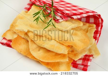 pieces of traditional Tuscan flatbread (Ghiottina Toscana) on checkered place mat - close up