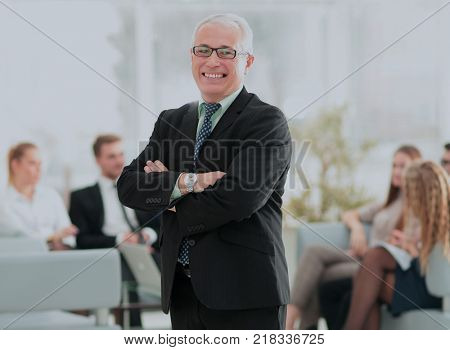 Portrait of happy businessman with  colleagues interacting on ba