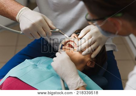 Close Up Process Of Preparing And Installing Dental Ceramic Crown. Male Professional Dentist Helps T