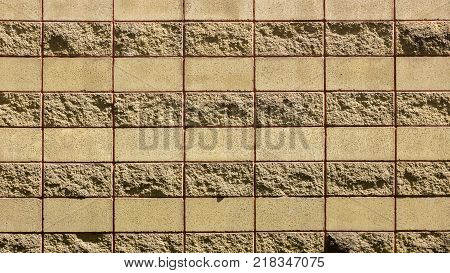 Decorative brick wall from concrete facing tiles as background or texture.