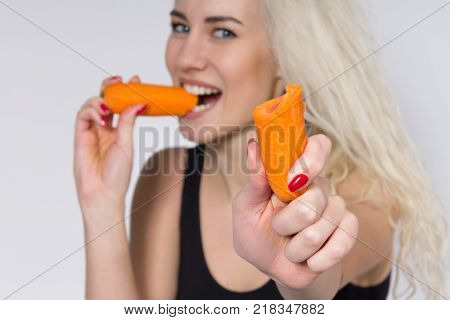 Young Woman Eating a Carrot. Vegetarianism. Diet