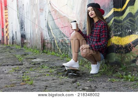Teen Girl with Skateboard and Coffee. Copy Space