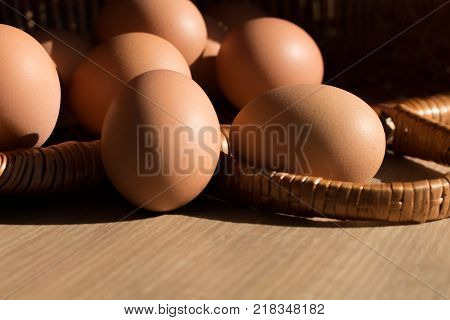 Chicken eggs in a basket. Copy Space