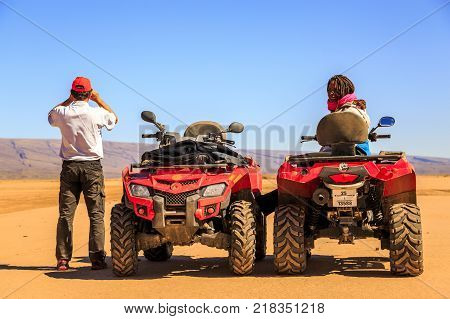 Ait Saoun Morocco - February 22 2016: African man and woman in buggy car at desert of Ait Saoun in Morocco.