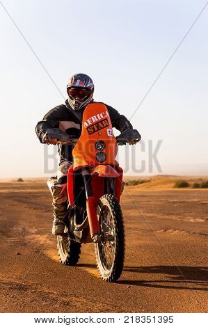 Ait Saoun Morocco - February 22 2016: Unidentified racer on a motorcycle in Moroccon desert Ait Saoun.