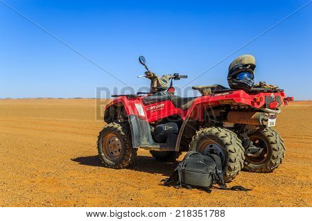Ait Saoun Morocco - February 23 2016: Red ATV Quad Bike on the sand dune in the desert