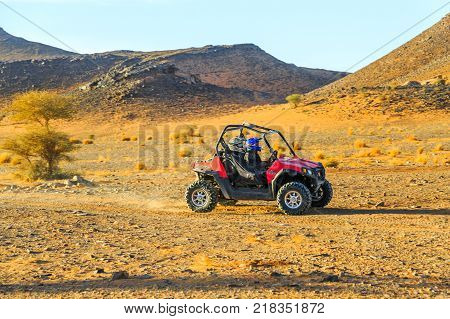 Ait Saoun Morocco - February 23 2016: Two people enjoying quad bike ride in Ait Saoun desert in Morocco.