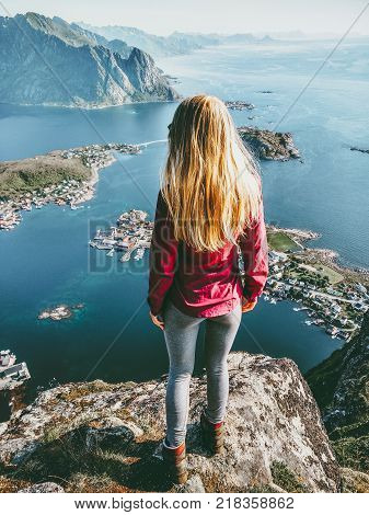 Traveling Woman on Reinebringen mointain over fjord Norway landscape Lifestyle success motivation concept adventure active vacations outdoor blonde hair girl