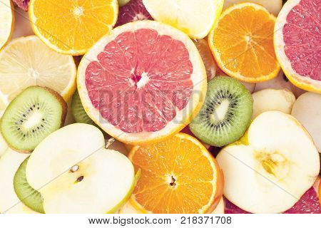 Grapefruit texture. Fruits as background texture pattern. lemon, orange kiwi citrus fruits half fruit wallpaper. Yellow orange, pink, green.