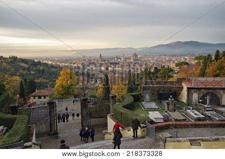 FLORENCE ITALY - NOVEMBER 7 2017: people at the exit of the Cimitero delle Porte Sante monumental cemetery with amazing view over the town