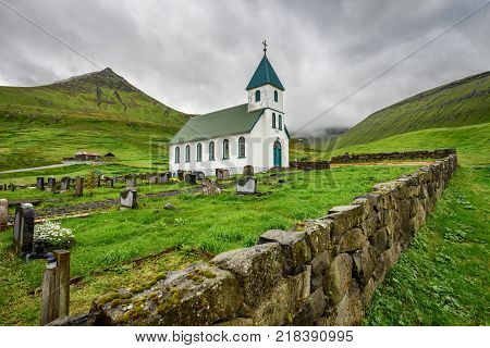 Small village church with cemetery in Gjogv located on the northeast tip of the island of Eysturoy, Faroe Islands, Denmark