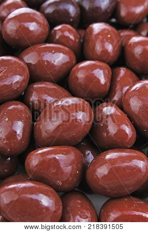 Dark and dairy chocolate balls. Chocolate drops as background texture pattern. Bon bons. Choco chocolate drops. Sweets.