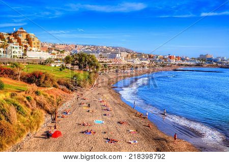 Beautiful panorama with people on summer holiday in Fanabe beach, on the coast Adeje in Canary island, Tenerife - Spain