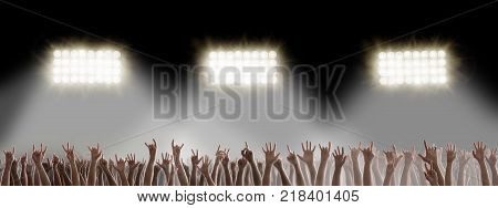 Raised hands in the dark on rock music concert. Hardrock music festival concept