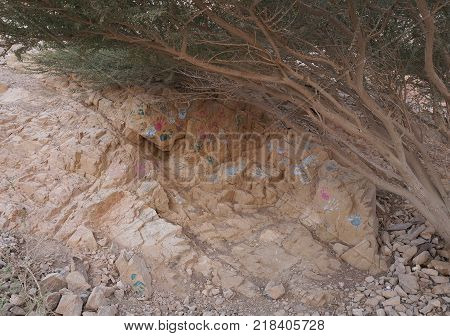 Hand prints of unknown people on the rock in desert