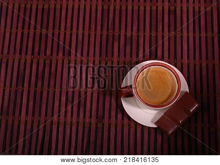 Coffee cup and chocolate on wooden table texture. Coffeebreak.