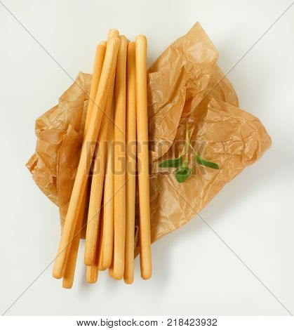 crispy bread sticks on creasy paper bag