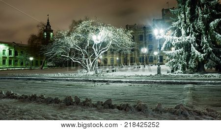Snowy evening landscape of the city square.