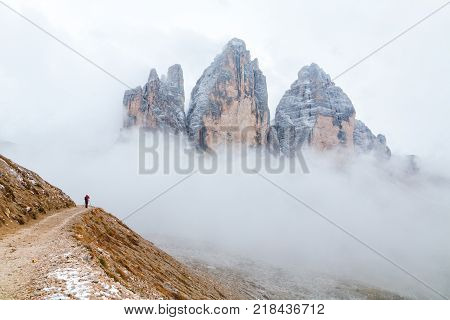 Tre Cime di Lavaredo in beautiful surroundings in the Dolomites at foggy weather in Italy Europe (Drei Zinnen)