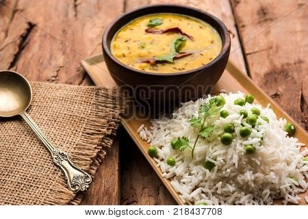 Basmati Rice Pilaf or pulav with Peas, or vegetable rice using green peas also known as matar pulav, served with plain dal