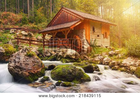 Old mill and beautiful Golling waterfall and near Golling and Salzach medieval town at autumn in Austria