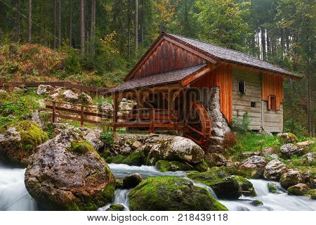 Old mill and beautiful Golling waterfall and near Golling and Salzach medieval town at autumn in Austria