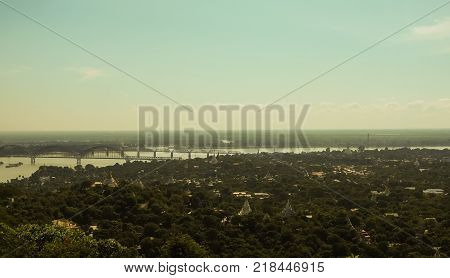 High angle view of multiple temples and pagodas on the mountains with Irrawaddy river in the background from sagaing hill, Sagaing region of Myanmar