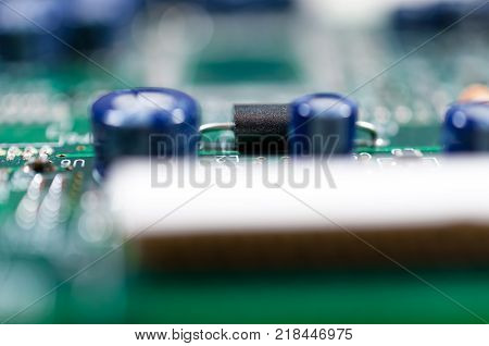 Computer parts close up shoton green board.
