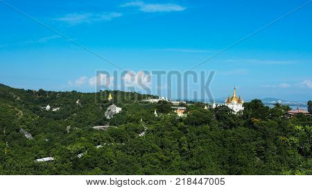 High angle view of multiple temples and pagodas on the mountains with Irrawaddy river in the background from sagaing hill, Sagaing region of Myanmar.