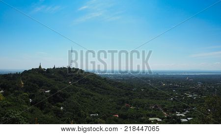 High angle view of multiple temples and pagodas on the mountains with Irrawaddy river in the background from sagaing hill, Sagaing region of Myanmar