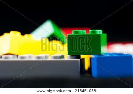 Colorful play construction bricks close up shot.