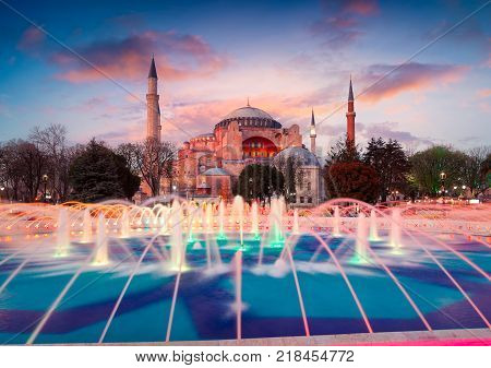 Colorful spring sunset in Sultan Ahmet park in Istanbul Turkey Europe. Colorful fountain on the background of the Ayasofya Museum (Hagia Sophia). Artistic style post processed photo.
