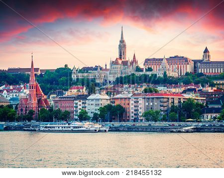 Evening view of Fisherman's Bastion and Zoltan Gozos museum. Colorful spring sunset in Budapest capital of Hungary Europe. Artistic style post processed photo.