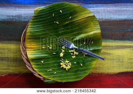 Dirty dish after food. The palm leaf and the remains of rice