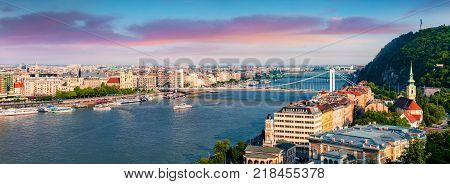 Panoramic cityscape of Pest city with Elisabeth Bridge on the Danube river. Colorful spring sunset in Budapest Hungary Europe. Artistic style post processed photo.