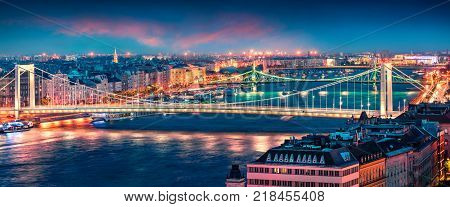 Panoramic cityscape of Pest city with Elisabeth Bridge on the Danube river. Colorful spring sunset in Budapest capital of Hungary Europe. Artistic style post processed photo.