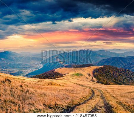 Dramatic autumn sunrise in the mountain village. Colorful morning scene in Carpathians Ukraine Europe. Artistic style post processed photo.