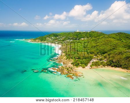 An aerial view of Byron Bay on a clear day with blue water