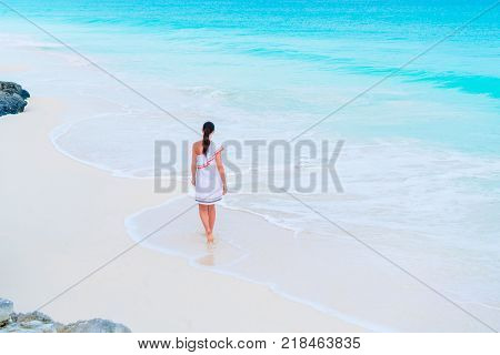 Adorable active girl at beach during summer vacation