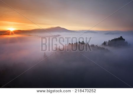 Misty Morning atmosphere in Szech Saxonz Switzerland. Sunrise in beautiful mountain with inversion.