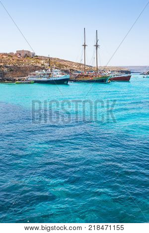 BLUE LAGOON MALTA - JUNE 25 2012: Leisure boats loaded with tourists moored at the Blue Lagoon in Malta.