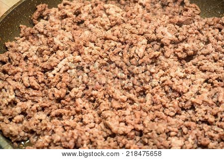 Closeup of minced meat being cooked on skillet