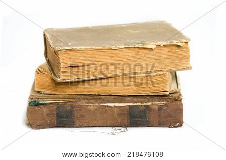 A stack of shabby old books on a white background